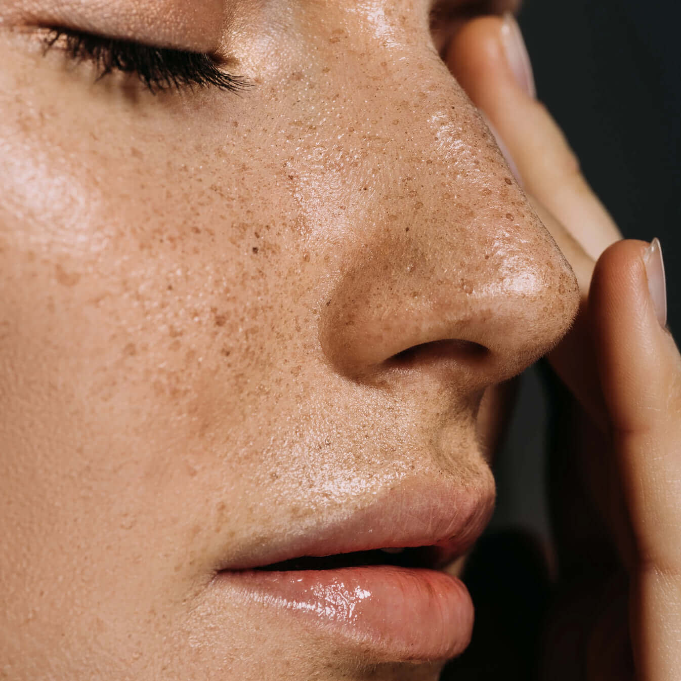 Close-up of a woman's smooth, hydrated face with a flawless complexion, showcasing the effects of ROSE-FLAWLESS skincare products.